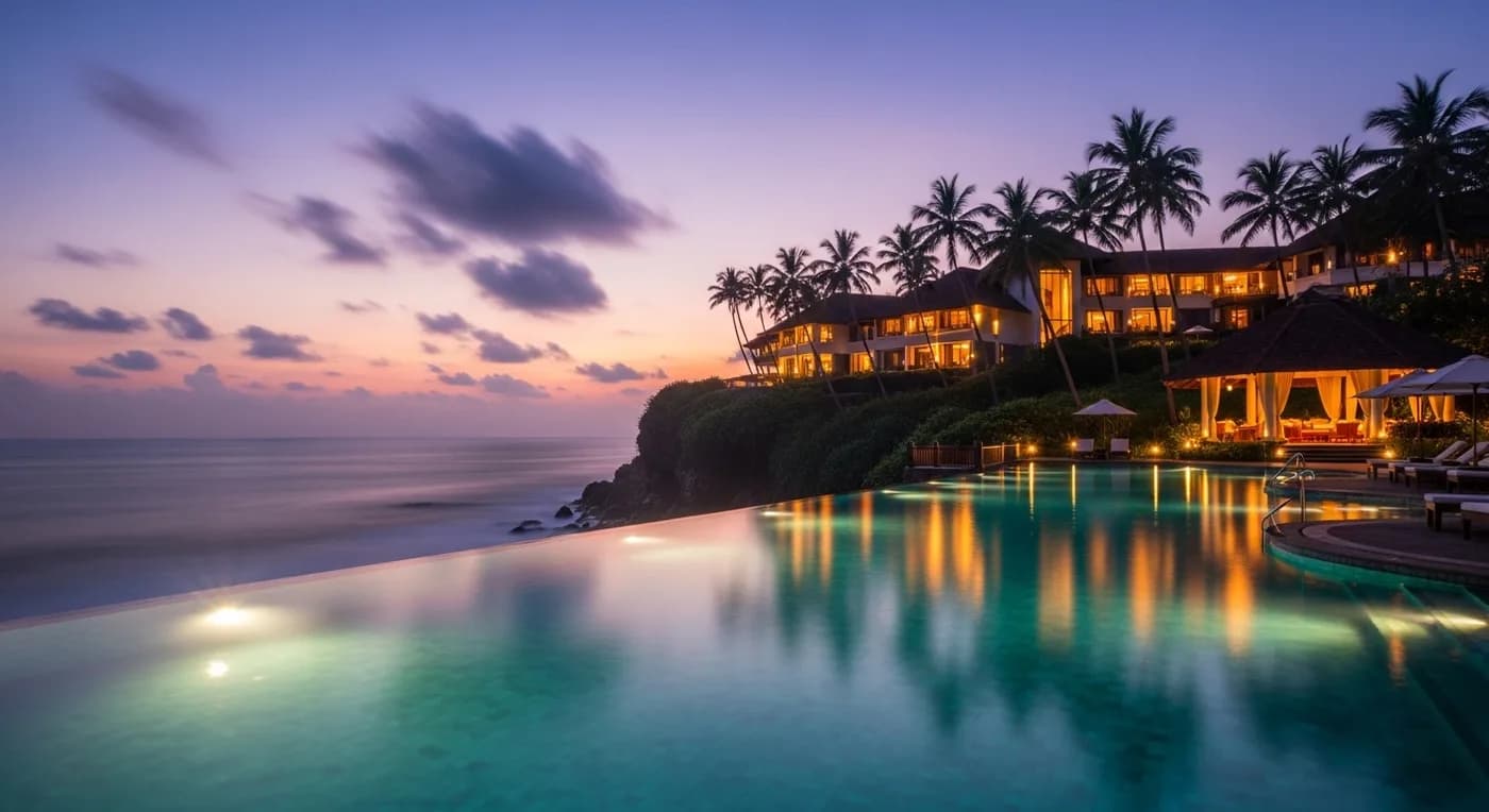 The Leela Kovalam resort at dusk with infinity pool and Arabian Sea
